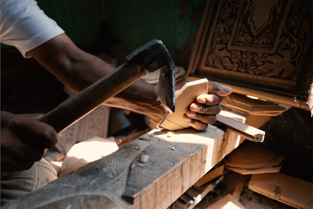 a-man-is-working-on-a-piece-of-wood-58bw-dfgqx4
